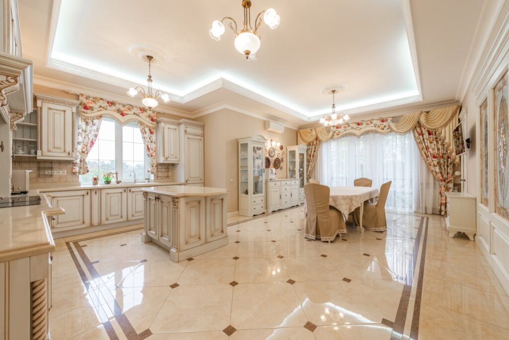 Bright, spacious kitchen and dining room with classic decor and chandeliers.